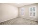 Neutral bedroom featuring carpet floors and bright, natural light from shuttered windows at 1545 Heritage Trl, Roswell, GA 30075