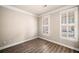 Cozy bedroom with hardwood floors, neutral walls, and natural light from shuttered windows at 1545 Heritage Trl, Roswell, GA 30075