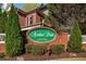 Welcoming entrance to Azalea Point, featuring lush greenery and a brick sign at 1545 Heritage Trl, Roswell, GA 30075