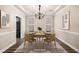 Elegant dining room showcasing stylish furniture, modern light fixture, and neutral decor; virtually staged at 1545 Heritage Trl, Roswell, GA 30075