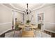Staged dining room design with modern decor, table setting, and area rug at 1545 Heritage Trl, Roswell, GA 30075