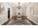 Dining room with modern decor, chandelier, rug, and windows with natural light at 1545 Heritage Trl, Roswell, GA 30075