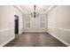 Elegant dining room featuring hardwood floors, chandelier, and natural light from shuttered windows at 1545 Heritage Trl, Roswell, GA 30075