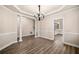 Bright dining room with wood floors, decorative molding, and a modern chandelier at 1545 Heritage Trl, Roswell, GA 30075