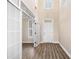 Bright foyer with hardwood flooring, a transom window, and white trim leading to other rooms at 1545 Heritage Trl, Roswell, GA 30075
