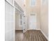 Bright foyer featuring hardwood floors, neutral walls, and a view of the staircase at 1545 Heritage Trl, Roswell, GA 30075