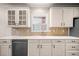 Close-up of a well-lit kitchen with white cabinets and stainless-steel dishwasher at 1545 Heritage Trl, Roswell, GA 30075