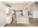 Spacious kitchen features white cabinets, stainless steel appliances, and hardwood flooring at 1545 Heritage Trl, Roswell, GA 30075