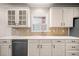 Bright kitchen features white cabinetry, light countertops and tile backsplash at 1545 Heritage Trl, Roswell, GA 30075