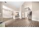 Bright, open living space features a fireplace, a view of the kitchen, and staircase at 1545 Heritage Trl, Roswell, GA 30075