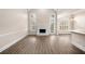 Sun-filled living room with tall ceilings, gas fireplace, and wood flooring at 1545 Heritage Trl, Roswell, GA 30075