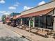 Street view with storefronts, outdoor seating, benches, and awnings, creating a vibrant urban atmosphere at 1545 Heritage Trl, Roswell, GA 30075