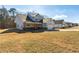 Wide view of a craftsman style home displaying the architectural details, lawn and surrounding neighborhood at 188 Harmony Woods Dr, Dallas, GA 30157