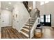 Welcoming foyer with staircase, hardwood floors, neutral paint, and decorative accents for a stylish entrance at 188 Harmony Woods Dr, Dallas, GA 30157