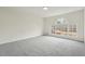 Neutral bedroom with large window offering natural light and plush carpet at 332 Stonecutters Cv, Stockbridge, GA 30281