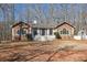 Charming stone-accented home with a welcoming front yard and a quaint white picket fence and arbor at 332 Stonecutters Cv, Stockbridge, GA 30281