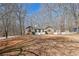 View of the exterior of a stone accented home with a nice front yard surrounded by trees at 332 Stonecutters Cv, Stockbridge, GA 30281