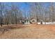 View of the front of a beautiful stone accented home with a welcoming front yard and white picket fence at 332 Stonecutters Cv, Stockbridge, GA 30281