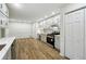 Well-lit kitchen with white cabinets, stainless steel appliances, wood floors, and a pantry at 332 Stonecutters Cv, Stockbridge, GA 30281