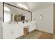 Bright bathroom featuring a double vanity with a decorative mirror at 492 Broadstone Nw Way, Acworth, GA 30101