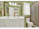 Well-lit bathroom featuring a double vanity with a decorative mirror and shower curtain at 492 Broadstone Nw Way, Acworth, GA 30101