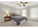 Comfortable bedroom with natural light, neutral walls, ceiling fan, and plush bedding, creating a cozy and relaxing space at 492 Broadstone Nw Way, Acworth, GA 30101