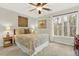 Bright bedroom features a ceiling fan and a large window at 492 Broadstone Nw Way, Acworth, GA 30101