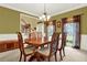 Elegant dining room with a wooden table and chairs, decorative chandelier, and olive green walls creating a warm space at 492 Broadstone Nw Way, Acworth, GA 30101