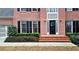 Close up of a beautiful brick home's entryway, featuring a black door with a wreath and sidelights at 492 Broadstone Nw Way, Acworth, GA 30101