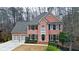 Charming two-story brick home with a well-manicured lawn, black shutters, and a two car garage at 492 Broadstone Nw Way, Acworth, GA 30101