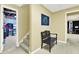 Neutral hallway features a bench and doorways leading to multiple rooms and the stairs at 492 Broadstone Nw Way, Acworth, GA 30101