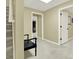 Neutral hallway featuring a staircase, bench, and multiple doorways in a well-lit space at 492 Broadstone Nw Way, Acworth, GA 30101