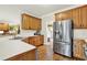 Bright kitchen includes stainless steel refrigerator and a view to the staircase at 492 Broadstone Nw Way, Acworth, GA 30101