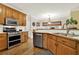 Traditional kitchen features wood cabinets, stainless steel appliances, and hardwood floors at 492 Broadstone Nw Way, Acworth, GA 30101