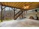 Covered patio with a ceiling fan, gas heater, and wooden stairs overlooking the yard at 492 Broadstone Nw Way, Acworth, GA 30101