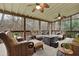 Relaxing screened porch with comfortable seating, ceiling fans, and a serene wooded view, perfect for outdoor enjoyment at 492 Broadstone Nw Way, Acworth, GA 30101