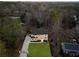 Aerial view of a modern two-story home featuring a lush green lawn and long driveway at 5238 Timber Ridge Rd, Marietta, GA 30068