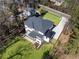 Aerial view of modern two-story home with a large backyard, deck, and long driveway at 5238 Timber Ridge Rd, Marietta, GA 30068