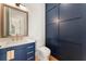 Modern bathroom featuring blue vanity, gold hardware, and elegant fixtures at 5238 Timber Ridge Rd, Marietta, GA 30068