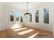 Bright breakfast area with multiple windows and a modern light fixture at 5238 Timber Ridge Rd, Marietta, GA 30068