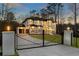 Elegant two-story home with modern design, black framed windows, gated entry and professional landscaping at 5238 Timber Ridge Rd, Marietta, GA 30068