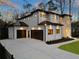 Stunning two-story home features modern garage doors, manicured lawn, and sleek black trim at 5238 Timber Ridge Rd, Marietta, GA 30068