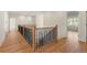 Upstairs hallway featuring modern railing and hardwood floors at 5238 Timber Ridge Rd, Marietta, GA 30068