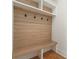 Cozy mudroom featuring a built-in bench, hooks, and shelving for organization at 5238 Timber Ridge Rd, Marietta, GA 30068