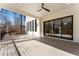 Stylish covered porch featuring wood flooring and sliding glass doors leading to the interior at 5238 Timber Ridge Rd, Marietta, GA 30068