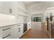 Stylish wet bar featuring white cabinetry, beverage cooler, and open shelving at 5238 Timber Ridge Rd, Marietta, GA 30068