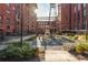 Exterior shot of the outdoor courtyard featuring an outdoor fireplace, hardscaping and greenery at 170 Boulevard Se # 111H, Atlanta, GA 30312