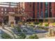 Exterior shot of the outdoor courtyard featuring an outdoor fireplace, hardscaping and greenery at 170 Boulevard Se # 111H, Atlanta, GA 30312