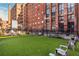 Outdoor dog park area with green turf, seating, and historic brick buildings in the background at 170 Boulevard Se # 111H, Atlanta, GA 30312