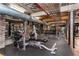 On-site gym featuring weights, weight machines, exposed brick, and exposed industrial ceiling elements at 170 Boulevard Se # 111H, Atlanta, GA 30312